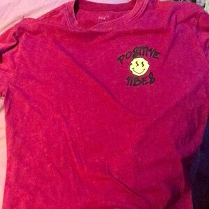 I’m selling this shirt it says Postive Vibes and has a lot of smiles on it